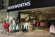 Shoppers walk into a Woolworths store at a shopping center in Lenasia, south of Johannesburg